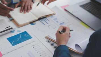Financial analysts analyze business financial reports on a digital tablet planning investment project during a discussion at a meeting of corporate showing the results of their successful teamwork. video