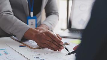 Financial analysts analyze business financial reports on a digital tablet planning investment project during a discussion at a meeting of corporate showing the results of their successful teamwork. video