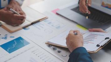 Financial analysts analyze business financial reports on a digital tablet planning investment project during a discussion at a meeting of corporate showing the results of their successful teamwork. video