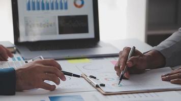 Financial analysts analyze business financial reports on a digital tablet planning investment project during a discussion at a meeting of corporate showing the results of their successful teamwork. video
