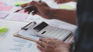 Financial analysts analyze business financial reports on a digital tablet planning investment project during a discussion at a meeting of corporate showing the results of their successful teamwork. video