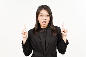 Showing Product and Pointing Up Of Beautiful Asian Woman Wearing Black Blazer Isolated On White photo