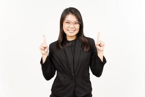 Showing Product and Pointing Up Of Beautiful Asian Woman Wearing Black Blazer Isolated On White photo