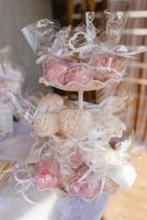 Homemade marshmallows on a three-tiered bookcase at a sweet bar at a wedding or party photo