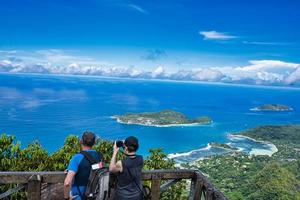 Mahe Seychelles 03.04.2023 Morn blanc nature trail, middle age couple at the viewpoint, taking pictures, Mahe Seychelles photo