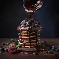 Stack of pancakes topped chocolate with berries. photo