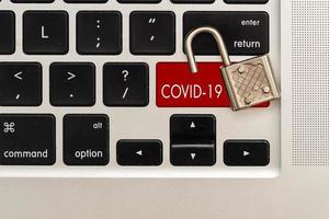 Red coronavirus button on the black computer keyboard. photo