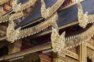 Thai style pattern on the temple roof of buddhist temple in thailand photo