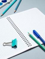 table with open notebook with ballpoint pen, stationery. Business concept planning a day, writing a to-do list, checklist. Top view of workspace photo