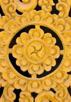 Pattern of flower carved on wood background. Traditional Thai style pattern photo
