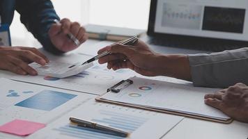 Financial analysts analyze business financial reports on a digital tablet planning investment project during a discussion at a meeting of corporate showing the results of their successful teamwork. video