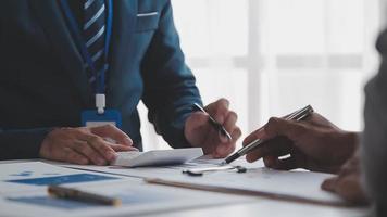 Financial analysts analyze business financial reports on a digital tablet planning investment project during a discussion at a meeting of corporate showing the results of their successful teamwork. video