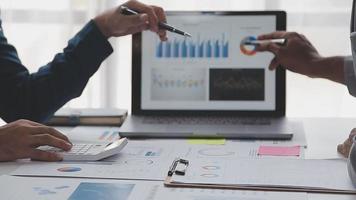 Financial analysts analyze business financial reports on a digital tablet planning investment project during a discussion at a meeting of corporate showing the results of their successful teamwork. video