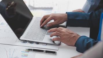 Financial analysts analyze business financial reports on a digital tablet planning investment project during a discussion at a meeting of corporate showing the results of their successful teamwork. video