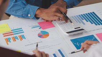 Financial analysts analyze business financial reports on a digital tablet planning investment project during a discussion at a meeting of corporate showing the results of their successful teamwork. video