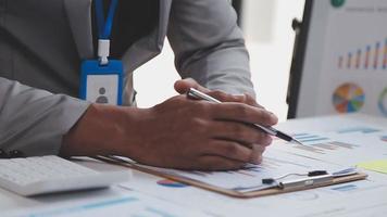 Financial analysts analyze business financial reports on a digital tablet planning investment project during a discussion at a meeting of corporate showing the results of their successful teamwork. video