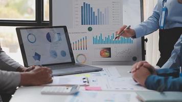 Financial analysts analyze business financial reports on a digital tablet planning investment project during a discussion at a meeting of corporate showing the results of their successful teamwork. video