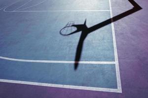 basketball hoop shadow on the basketball court photo