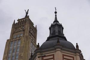 Various photos of madrid streets with colorful buildings and sky