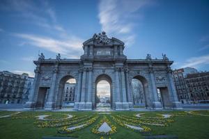 The Alcala Gate is a neoclassical monument located in the Plaza de la Independencia square in Madrid, the capital of Spain. photo