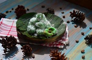 Klepon or kelepon is one of Indonesia's traditional cakes made from glutinous rice flour which is shaped like small balls and filled with brown sugar and then boiled photo