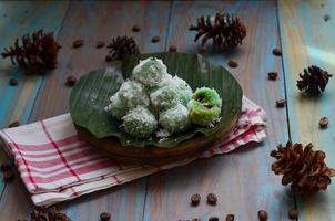 Klepon or kelepon is one of Indonesia's traditional cakes made from glutinous rice flour which is shaped like small balls and filled with brown sugar and then boiled photo