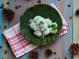 Klepon or kelepon is one of Indonesia's traditional cakes made from glutinous rice flour which is shaped like small balls and filled with brown sugar and then boiled photo