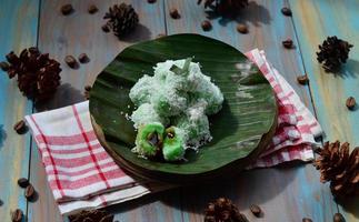 Klepon or kelepon is one of Indonesia's traditional cakes made from glutinous rice flour which is shaped like small balls and filled with brown sugar and then boiled photo