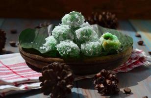 Klepon or kelepon is one of Indonesia's traditional cakes made from glutinous rice flour which is shaped like small balls and filled with brown sugar and then boiled photo
