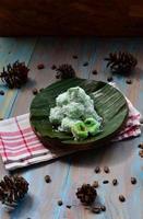 Klepon or kelepon is one of Indonesia's traditional cakes made from glutinous rice flour which is shaped like small balls and filled with brown sugar and then boiled photo