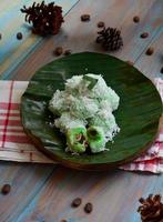 Klepon or kelepon is one of Indonesia's traditional cakes made from glutinous rice flour which is shaped like small balls and filled with brown sugar and then boiled photo