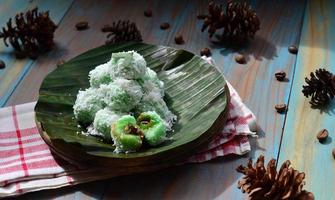 Klepon or kelepon is one of Indonesia's traditional cakes made from glutinous rice flour which is shaped like small balls and filled with brown sugar and then boiled photo