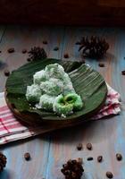 Klepon or kelepon is one of Indonesia's traditional cakes made from glutinous rice flour which is shaped like small balls and filled with brown sugar and then boiled photo