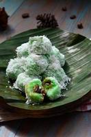 Klepon or kelepon is one of Indonesia's traditional cakes made from glutinous rice flour which is shaped like small balls and filled with brown sugar and then boiled photo