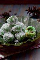 Klepon or kelepon is one of Indonesia's traditional cakes made from glutinous rice flour which is shaped like small balls and filled with brown sugar and then boiled photo