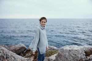portrait of a woman sweaters cloudy sea admiring nature Lifestyle photo