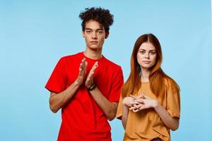 cheerful young couple in multicolored t-shirts cropped view studio fashion photo