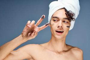 handsome guy with a towel on his head naked shoulders cosmetics clean skin photo