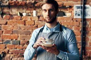 male waiter apron coffee cup work professional cafe photo