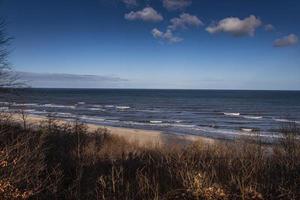 calm landscape of the beach on the Polish Baltic Sea on a cloudy February day photo