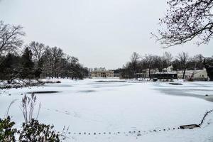 historic palace on the water in  park in Warsaw, Poland during snowy winter photo