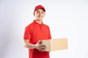 portrait of asian delivery man on white background photo