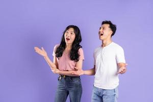 image of asian couple posing on purple background photo