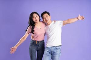 image of asian couple posing on purple background photo