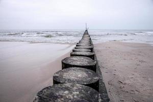 seaside landscape of the baltic sea on a calm day with a wooden breakwater photo