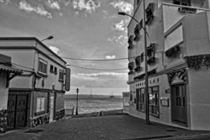 view of the white houses with blue shutters on the background of the oceans on the Spanish island of Furertaventra photo