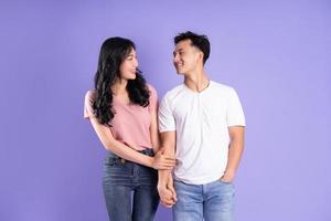 image of asian couple posing on purple background photo