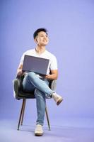 image of asian boy posing on purple background photo