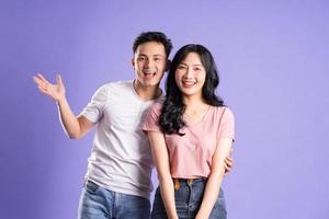 image of asian couple posing on purple background photo