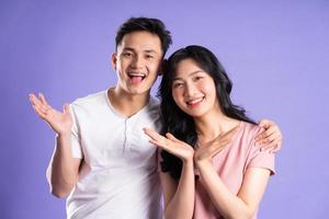 image of asian couple posing on purple background photo